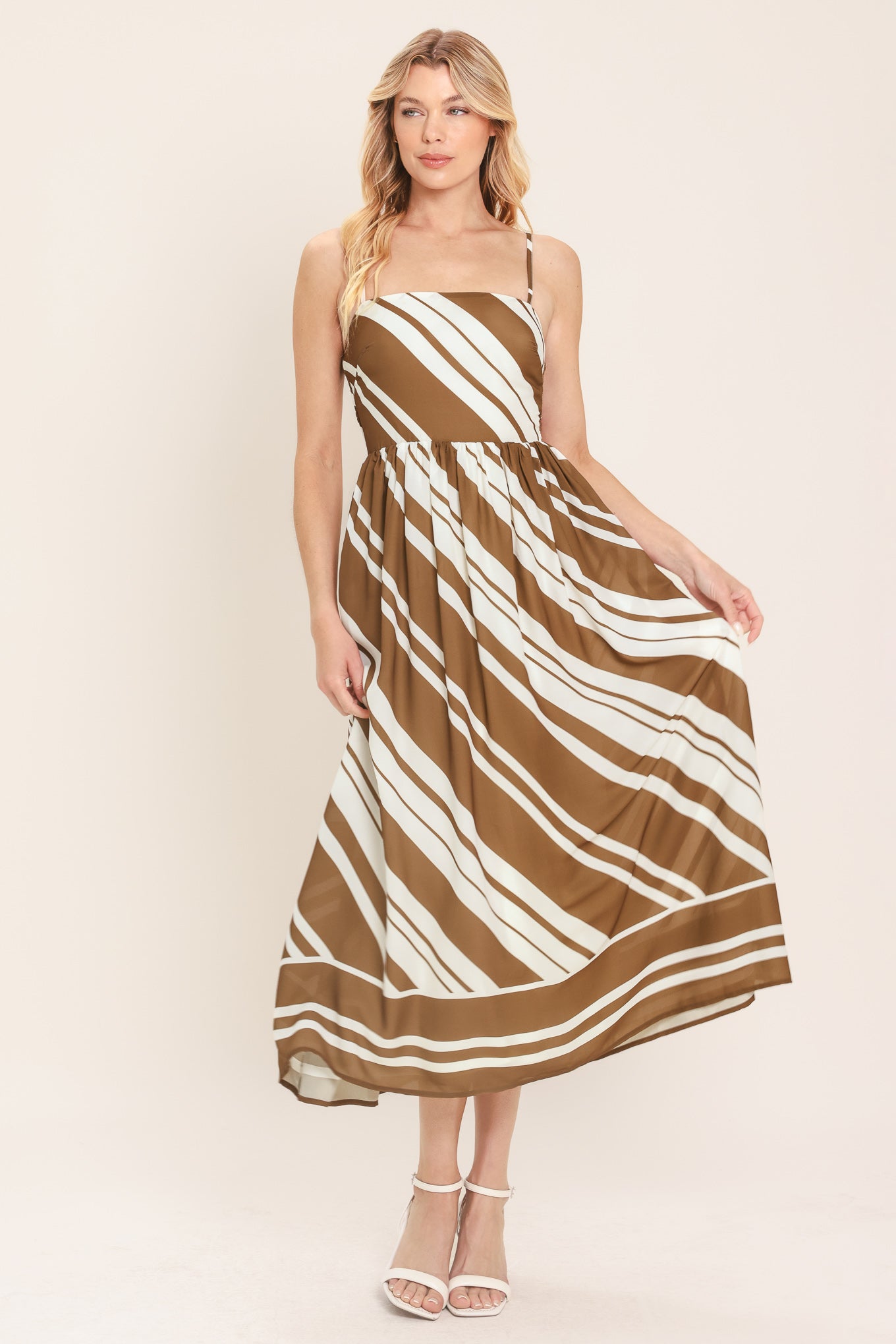 Woman wearing a brown and ivory diagonal striped midi dress | Flying Tomato