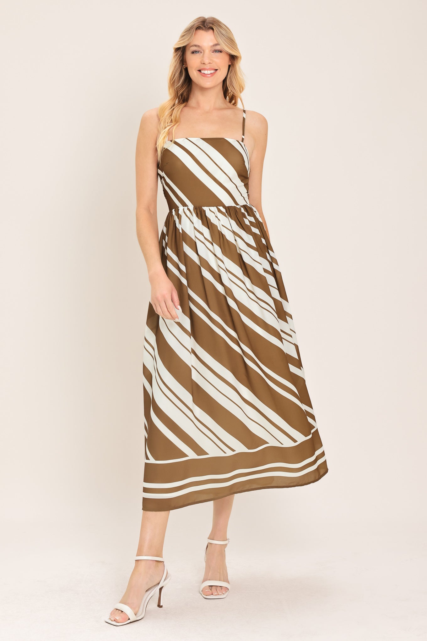 Woman wearing a brown and ivory diagonal striped midi dress | Flying Tomato