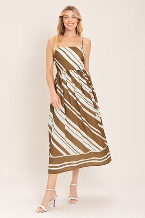 Woman wearing a brown and ivory diagonal striped midi dress | Flying Tomato