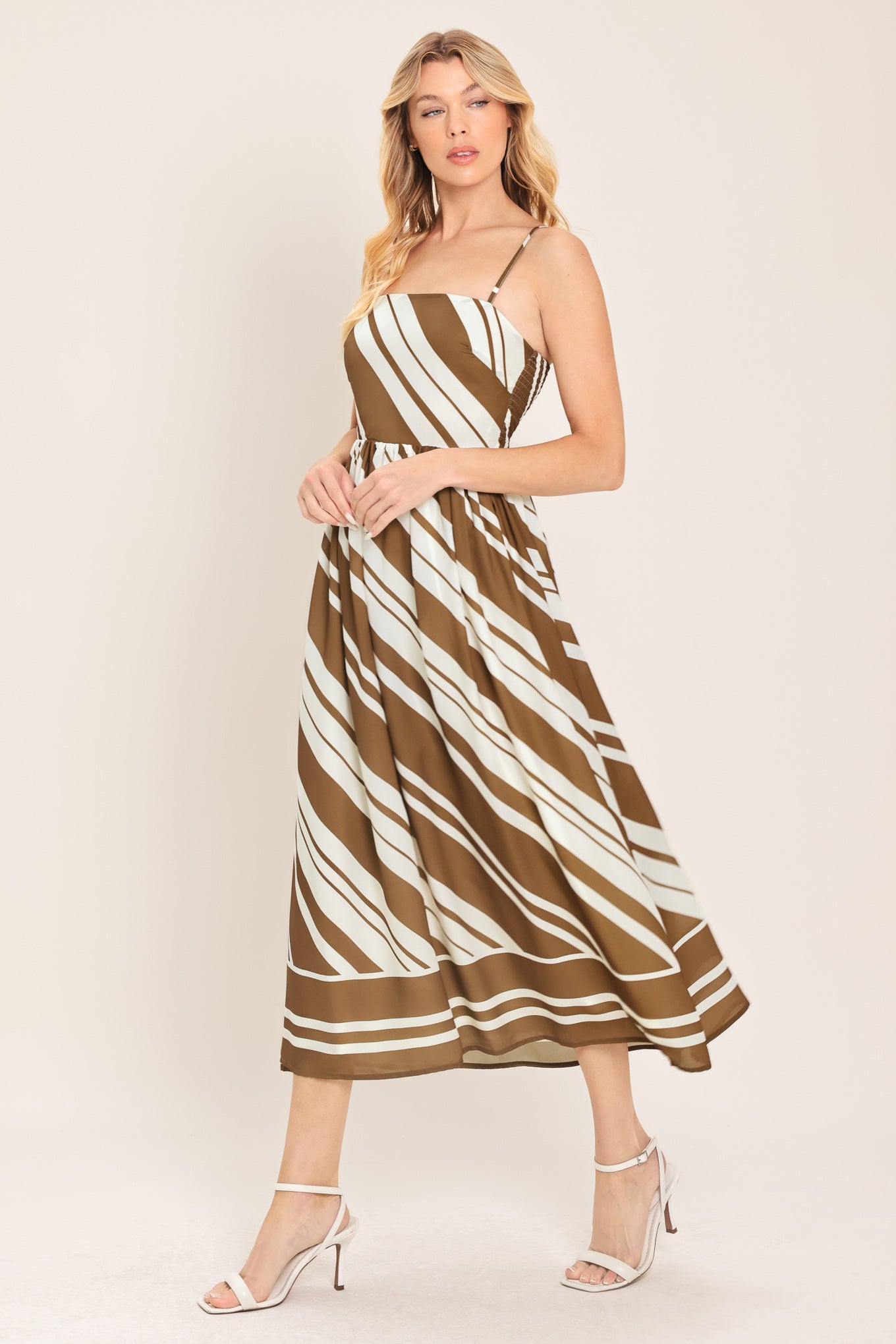 Woman wearing a brown and ivory diagonal striped midi dress | Flying Tomato