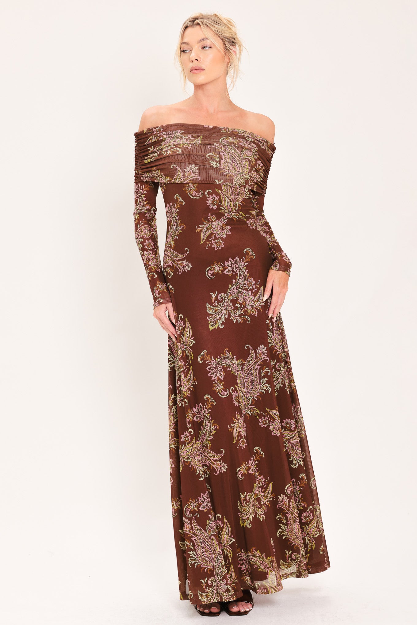An off-the-shoulder long-sleeve maxi dress in dark brown with an intricate paisley and floral pattern in beige, gold, and muted green | Flying Tomato