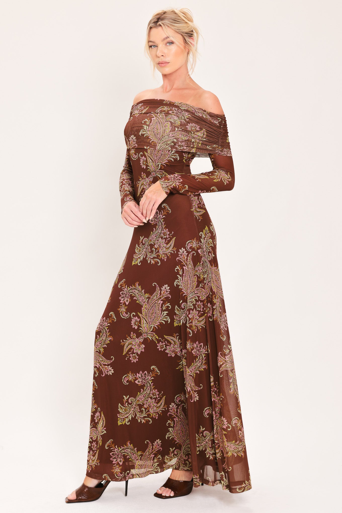 An off-the-shoulder long-sleeve maxi dress in dark brown with an intricate paisley and floral pattern in beige, gold, and muted green | Flying Tomato