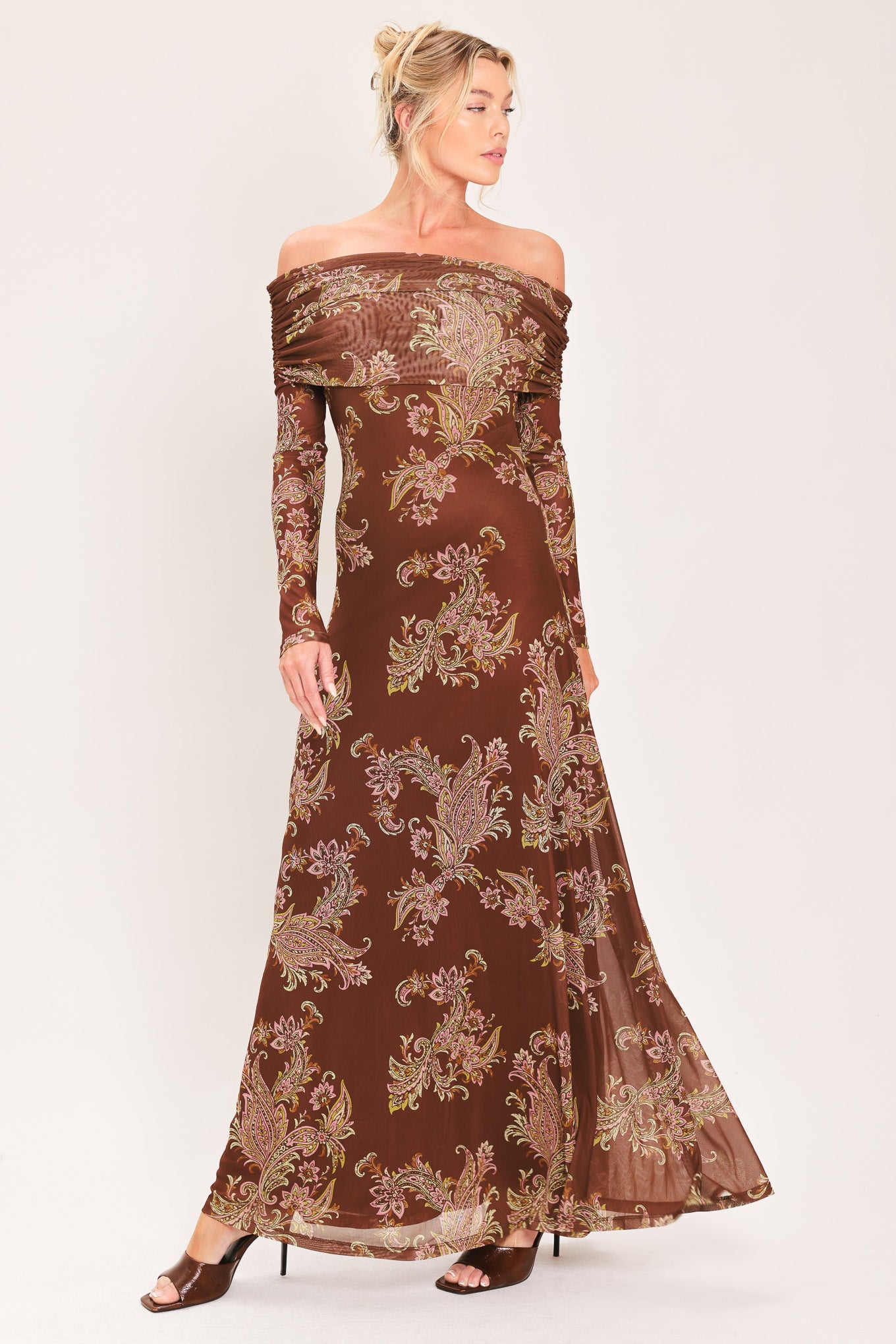 An off-the-shoulder long-sleeve maxi dress in dark brown with an intricate paisley and floral pattern in beige, gold, and muted green | Flying Tomato