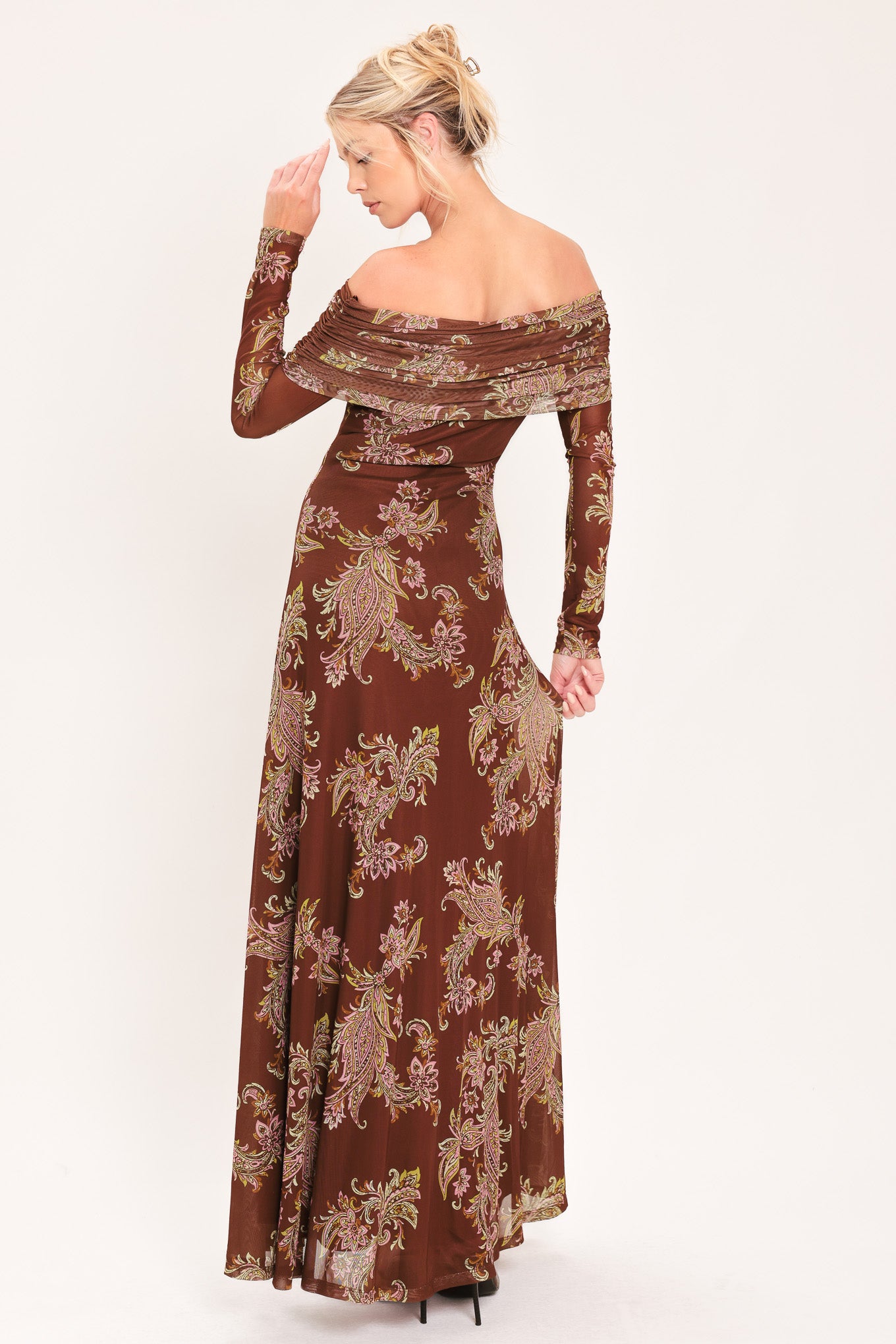 An off-the-shoulder long-sleeve maxi dress in dark brown with an intricate paisley and floral pattern in beige, gold, and muted green | Flying Tomato