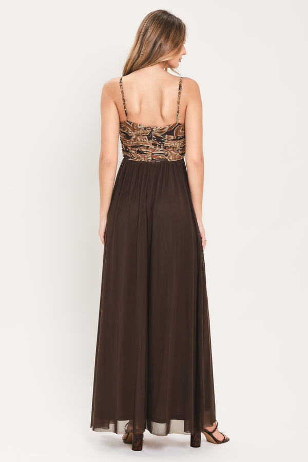 A woman modeling a long brown maxi dress with a patterned bodice and flowing power mesh skirt | Flying Tomato