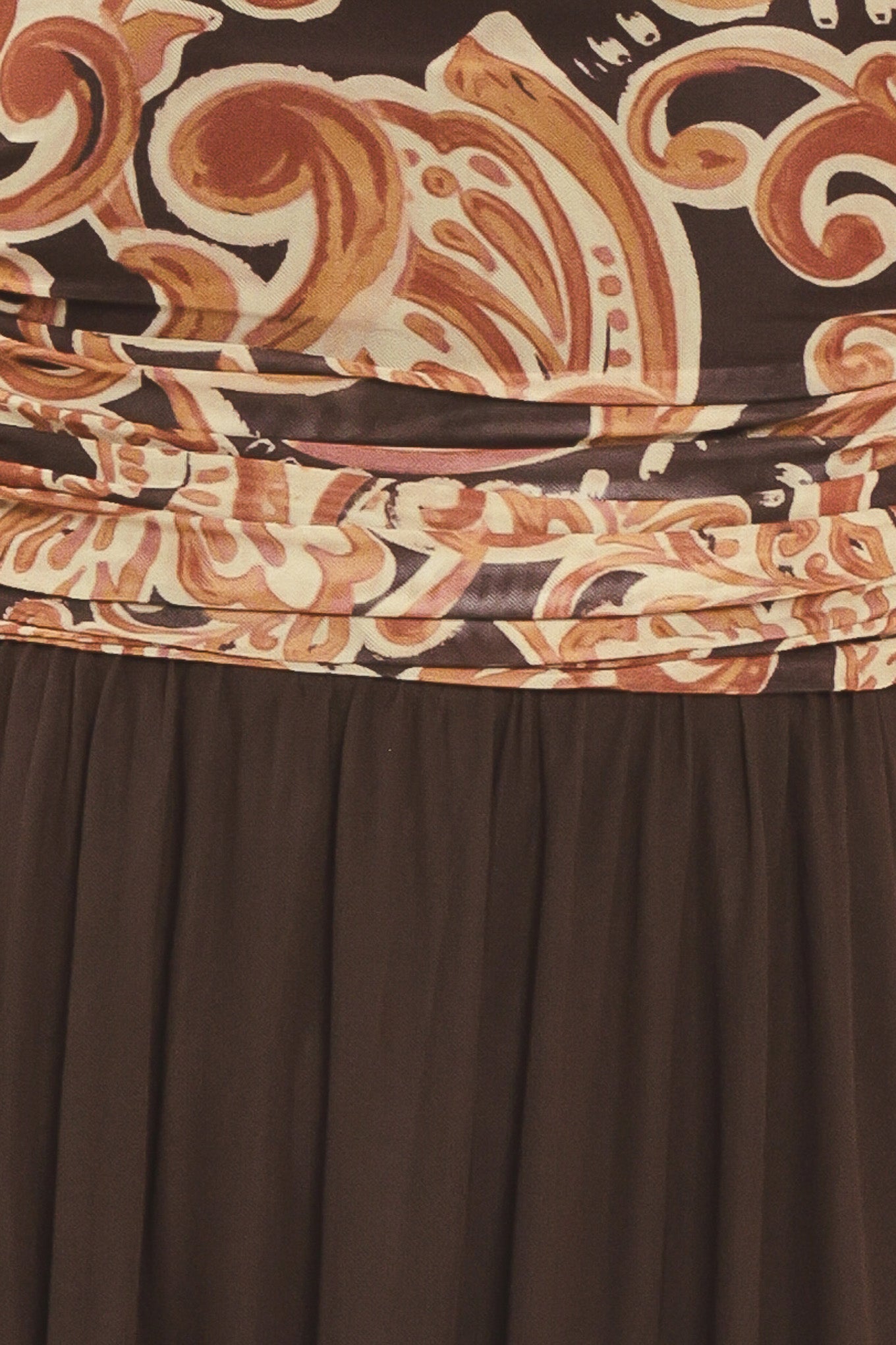A woman modeling a long brown maxi dress with a patterned bodice and flowing power mesh skirt | Flying Tomato