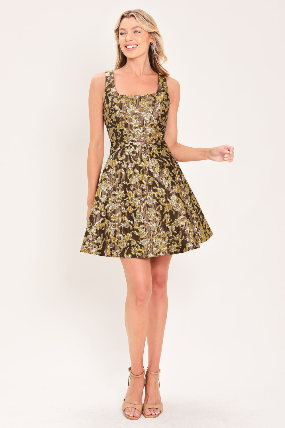 A woman modeling a sleeveless fit-and-flare dress with a brown, gold, and beige floral jacquard pattern | Flying Tomato