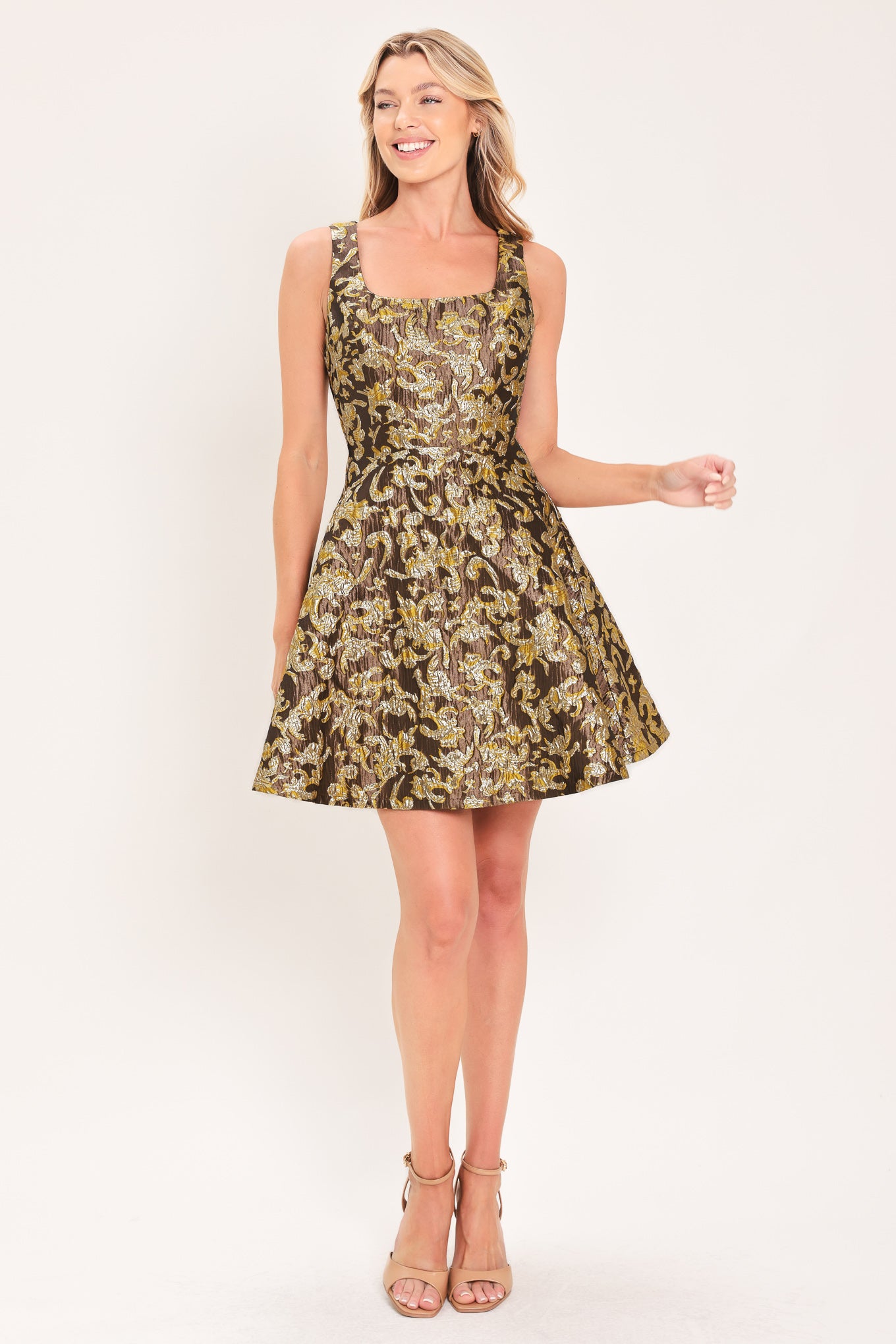 A woman modeling a sleeveless fit-and-flare dress with a brown, gold, and beige floral jacquard pattern | Flying Tomato