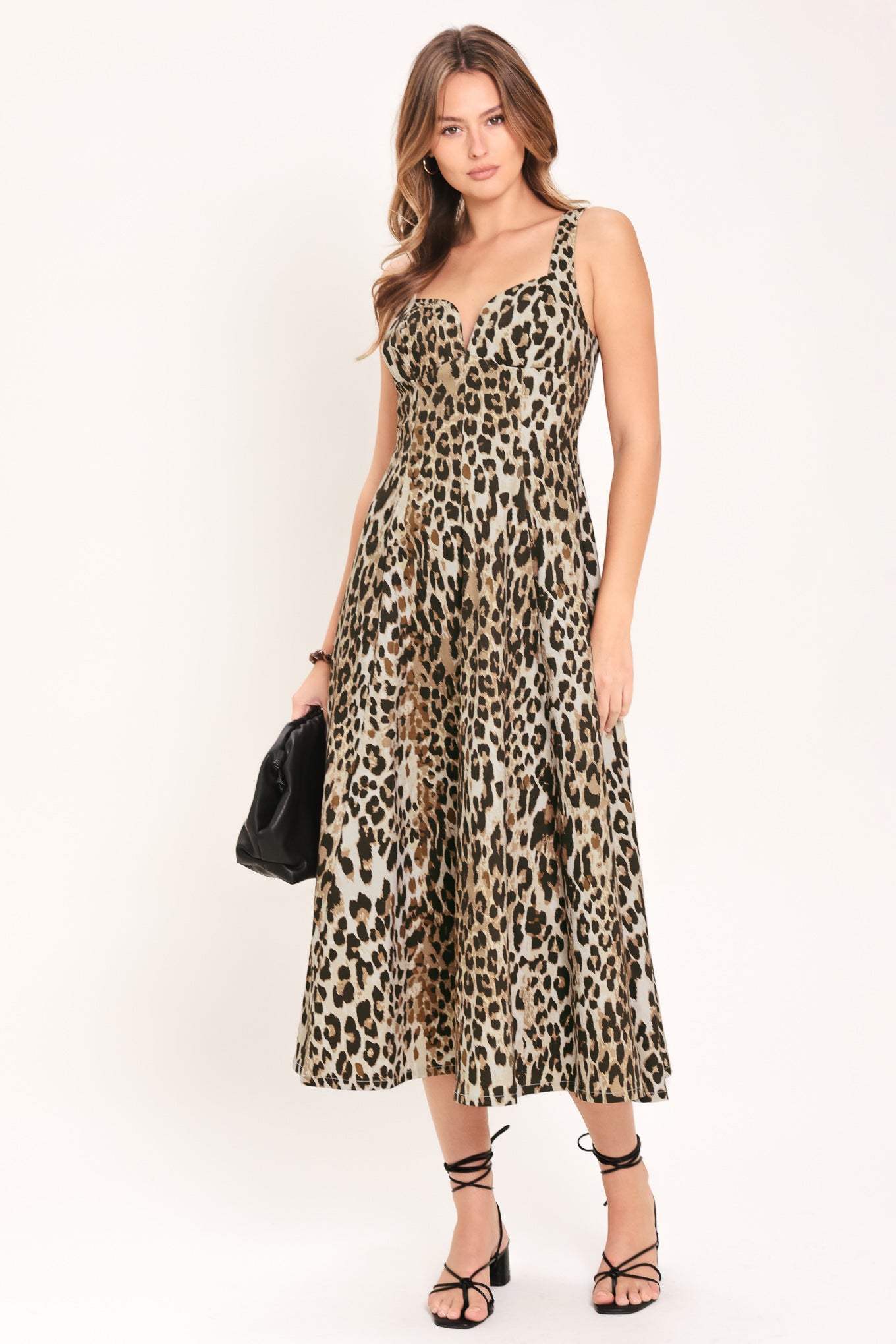 Woman wearing a sleeveless leopard print midi dress featuring sweetheart neckline, circle skirt and back zipper closure | Flying Tomato