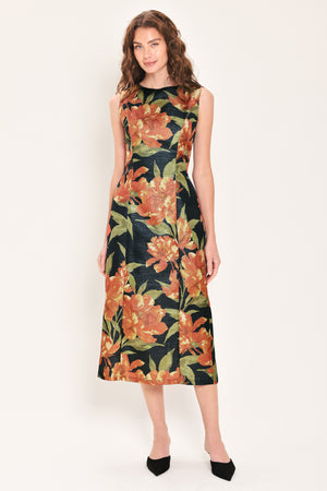Woman wearing a sleeveless black midi sheath dress with orange flowers and green leaves printed | Flying Tomato
