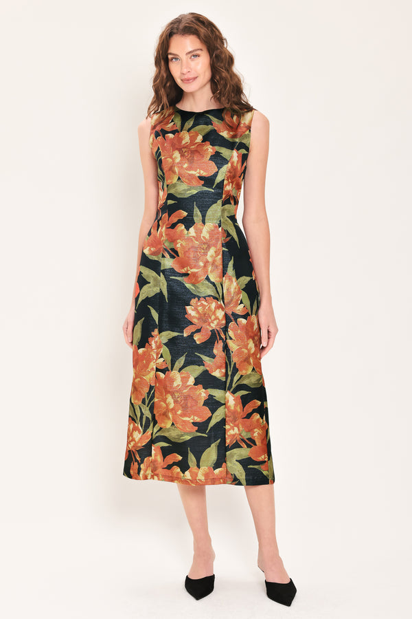Woman wearing a sleeveless black midi sheath dress with orange flowers and green leaves printed | Flying Tomato
