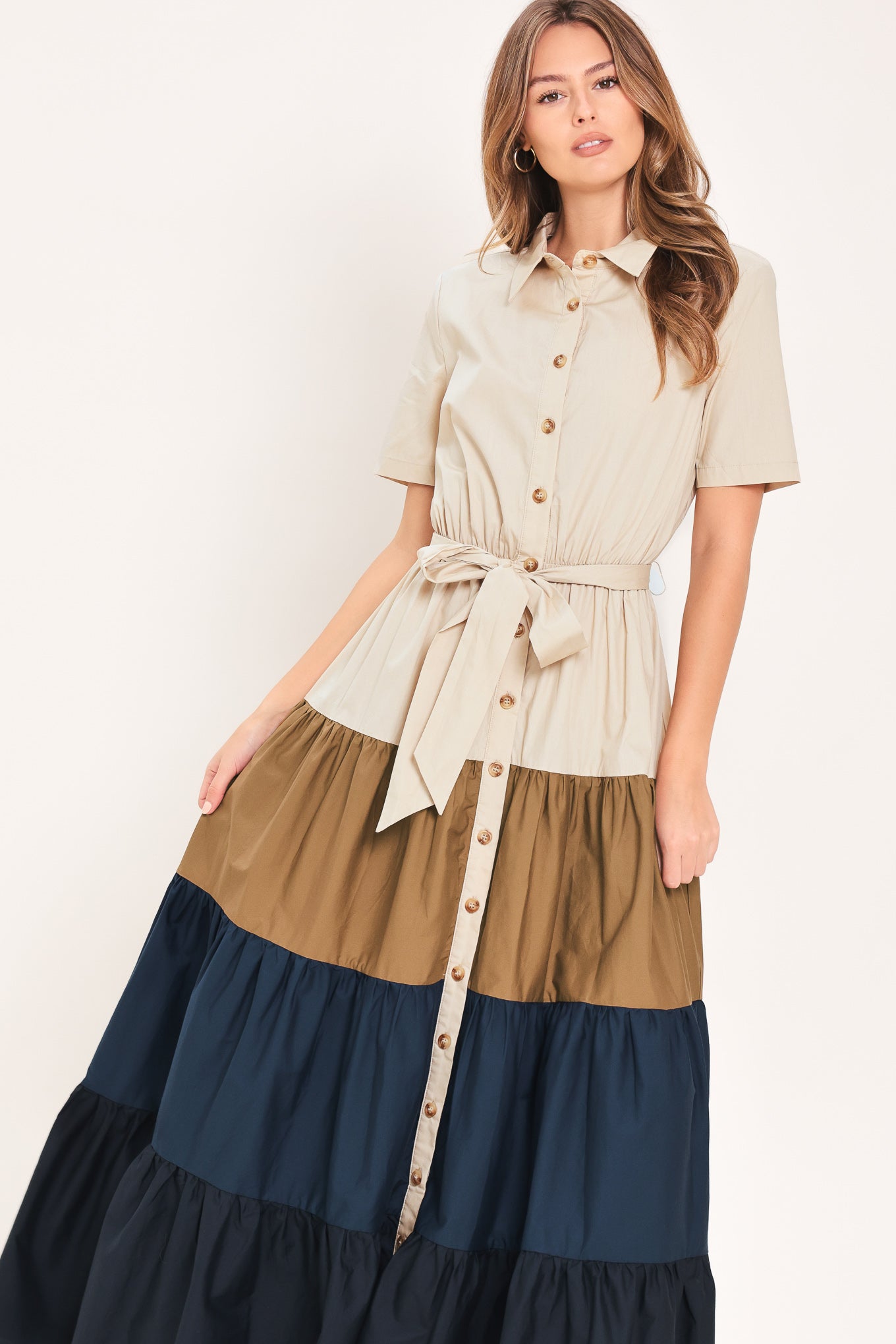 Woman wearing a color-blocked midi dress with beige, brown, and navy | Flying Tomato