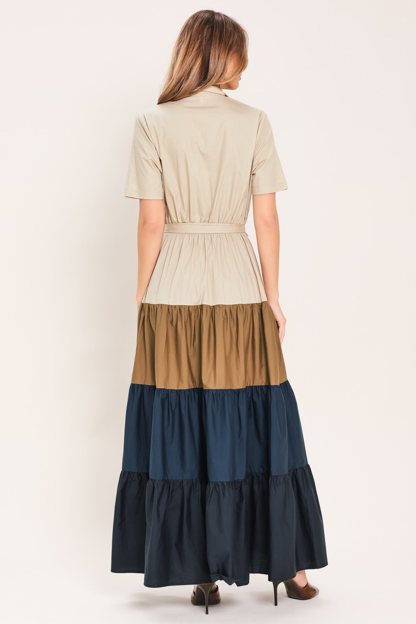 Woman wearing a color-blocked midi dress with beige, brown, and navy | Flying Tomato