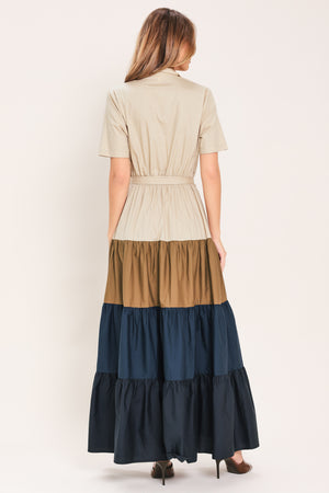 Woman wearing a color-blocked midi dress with beige, brown, and navy | Flying Tomato
