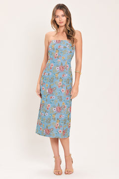 A woman models a strapless midi dress with a light blue base and a colorful floral pattern | Flying Tomato
