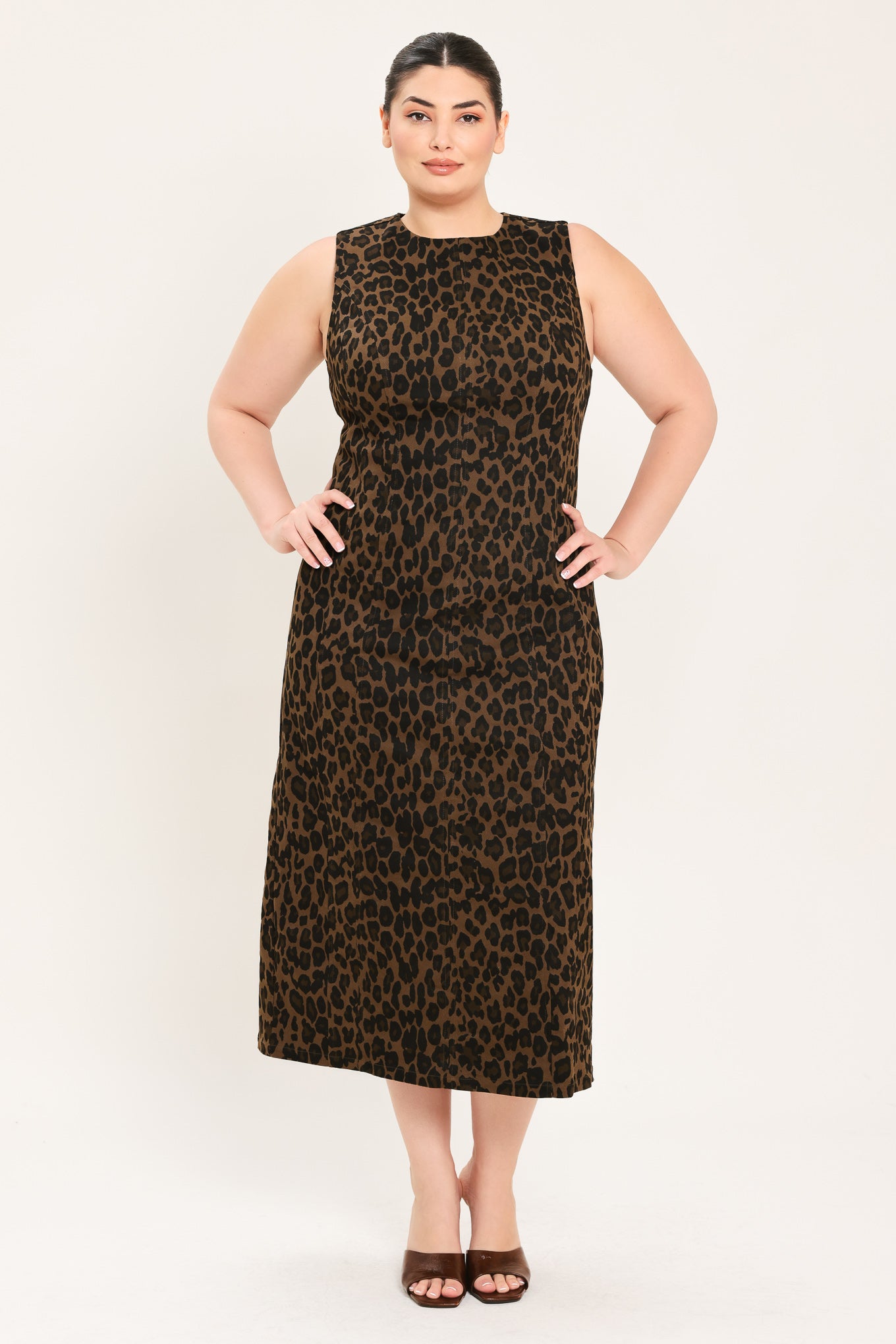 A woman modeling a sleeveless, midi leopard print dress in brown and black |Plus Curve Flying Tomato