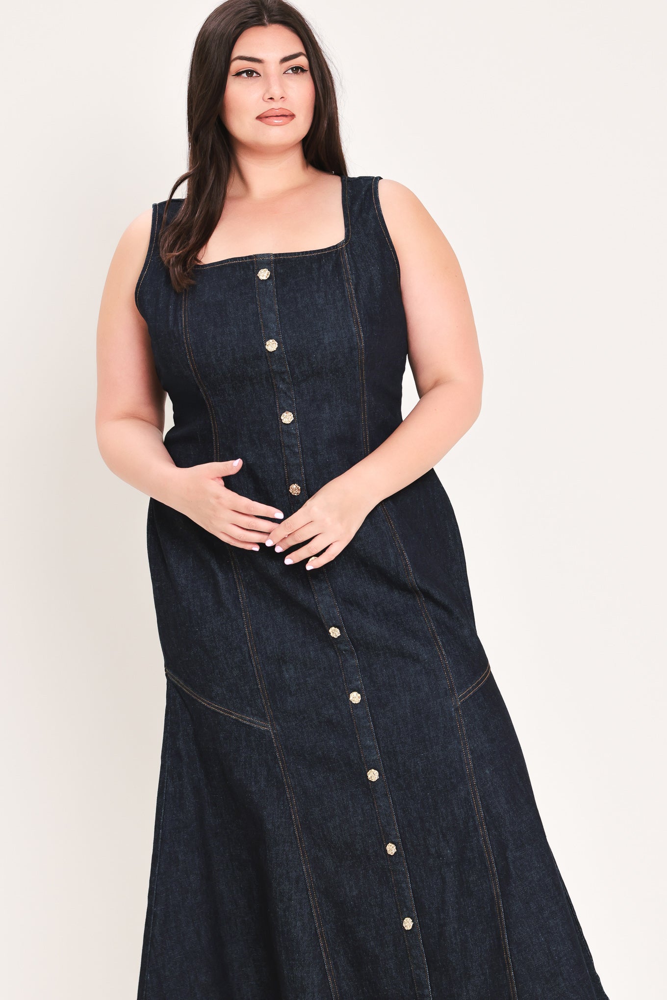 Woman wearing a dark denim dress with buttons on a white background | Flying Tomato Curve
