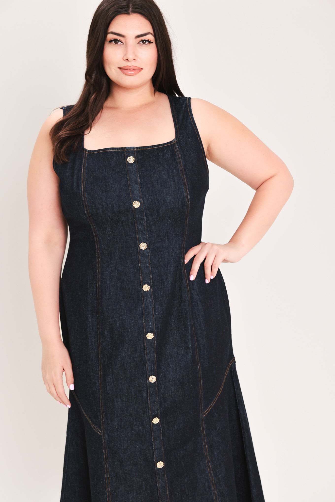 Woman wearing a dark denim dress with buttons on a white background | Flying Tomato Curve