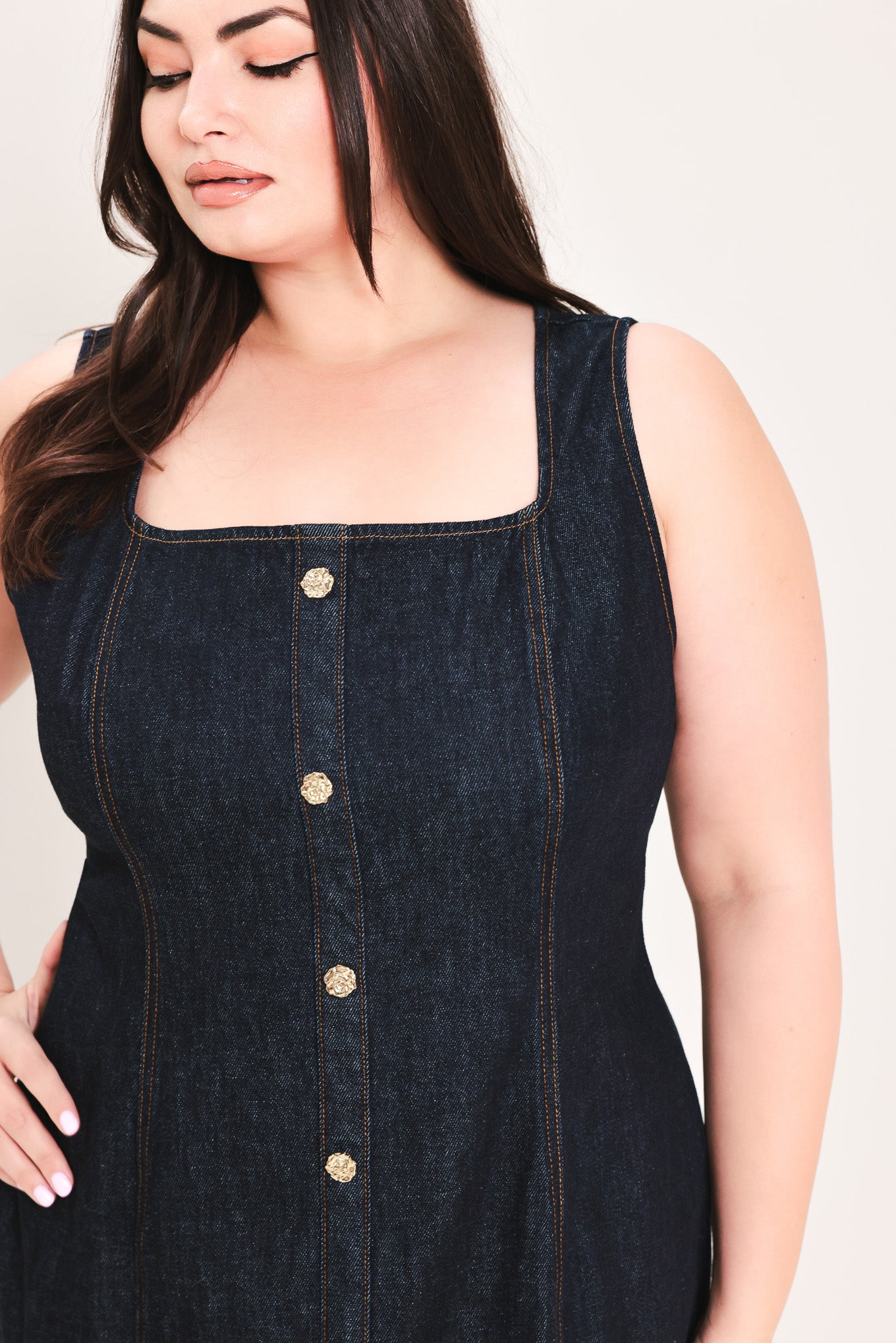 Woman wearing a dark denim dress with buttons on a white background | Flying Tomato Curve