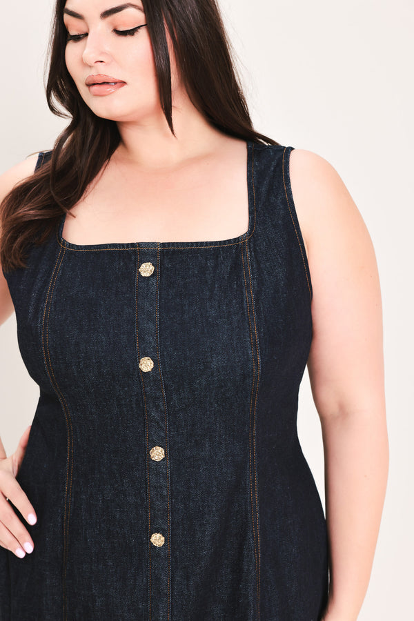 Woman wearing a dark denim dress with buttons on a white background | Flying Tomato Curve