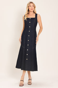 Woman wearing a dark indigo denim sleeveless midi dress with buttons | Flying Tomato