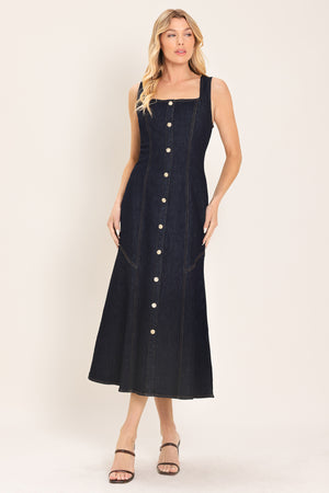 Woman wearing a dark indigo denim sleeveless midi dress with buttons | Flying Tomato
