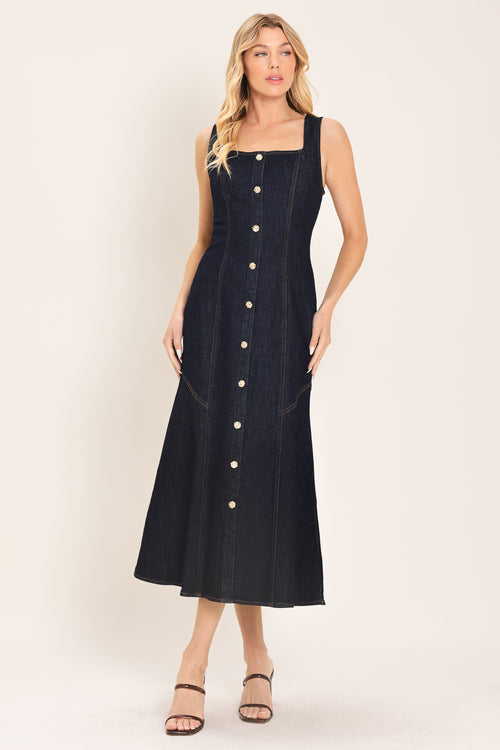 Woman wearing a dark indigo denim sleeveless midi dress with buttons | Flying Tomato