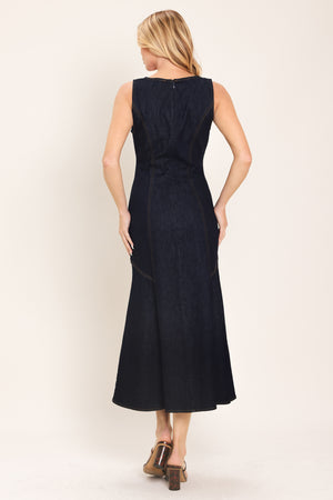 Woman wearing a dark indigo denim sleeveless midi dress with buttons | Flying Tomato
