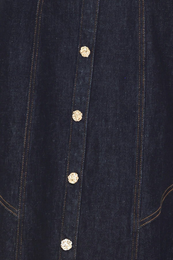 Woman wearing a dark indigo denim sleeveless midi dress with buttons | Flying Tomato