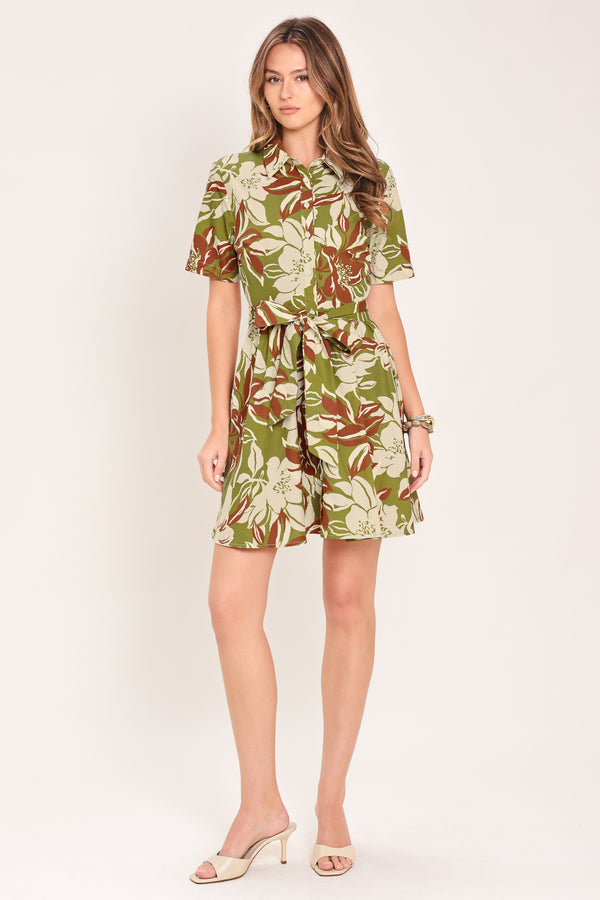 Woman wearing an olive green floral mini shirt dress with front button closure, short sleeve, self sash and full skirt | Flying Tomato