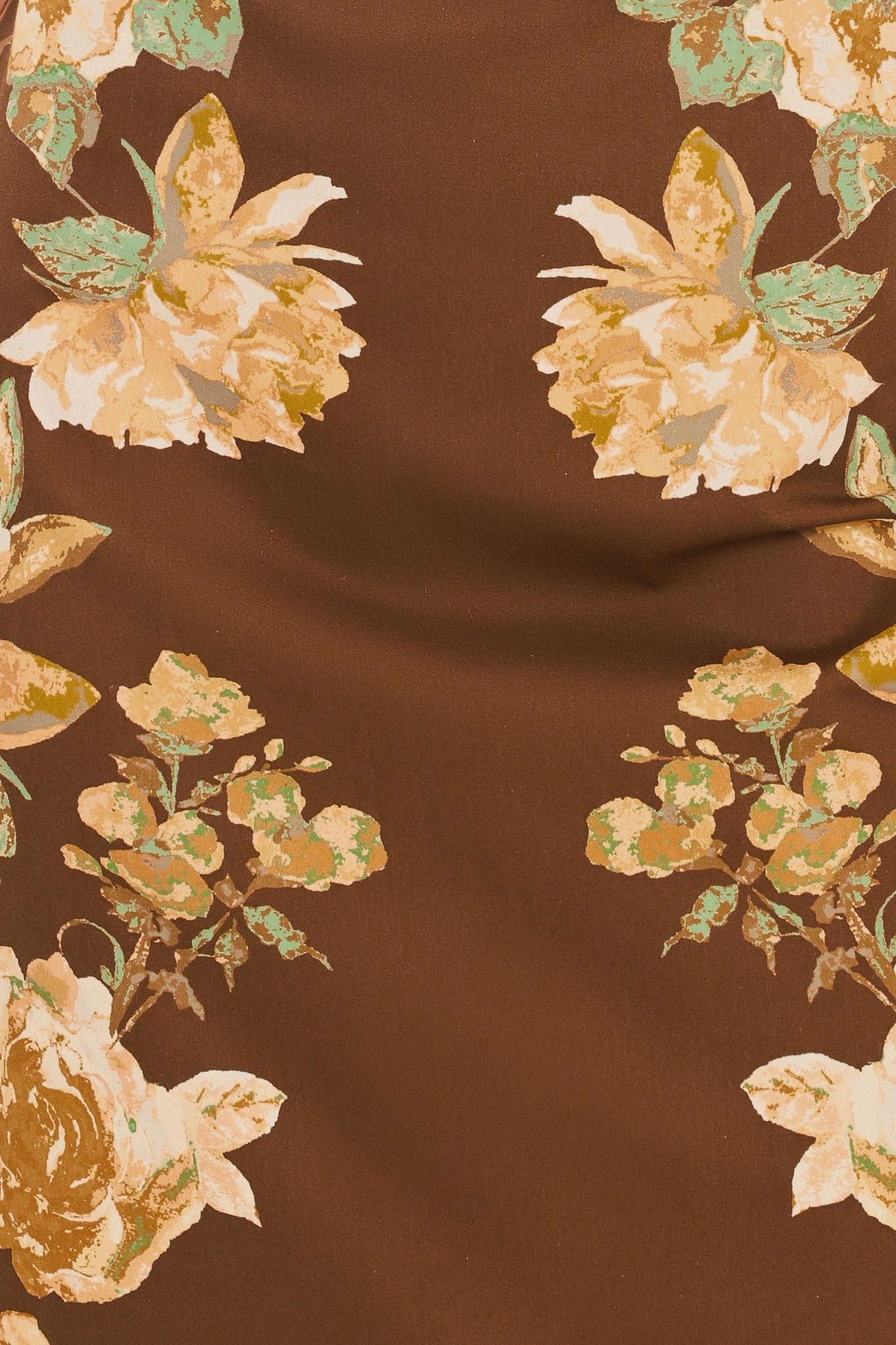 A woman modeling a sleeveless brown midi dress with a large yellow and green floral print | Flying Tomato