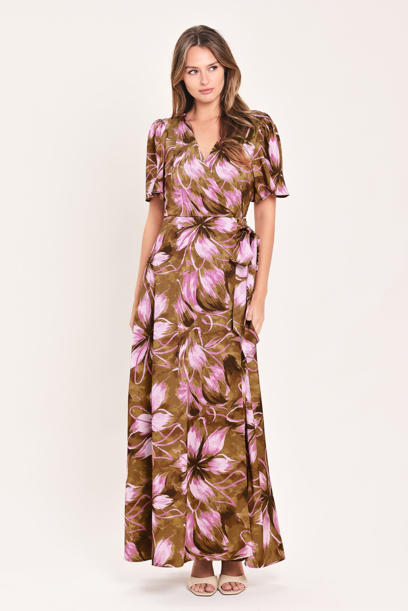 A woman modeling a brown and pink floral maxi dress with puff sleeves and a V-neckline | Flying Tomato