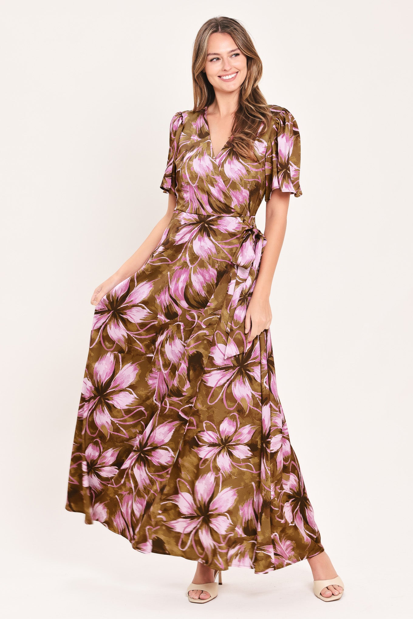 A woman modeling a brown and pink floral maxi dress with puff sleeves and a V-neckline | Flying Tomato
