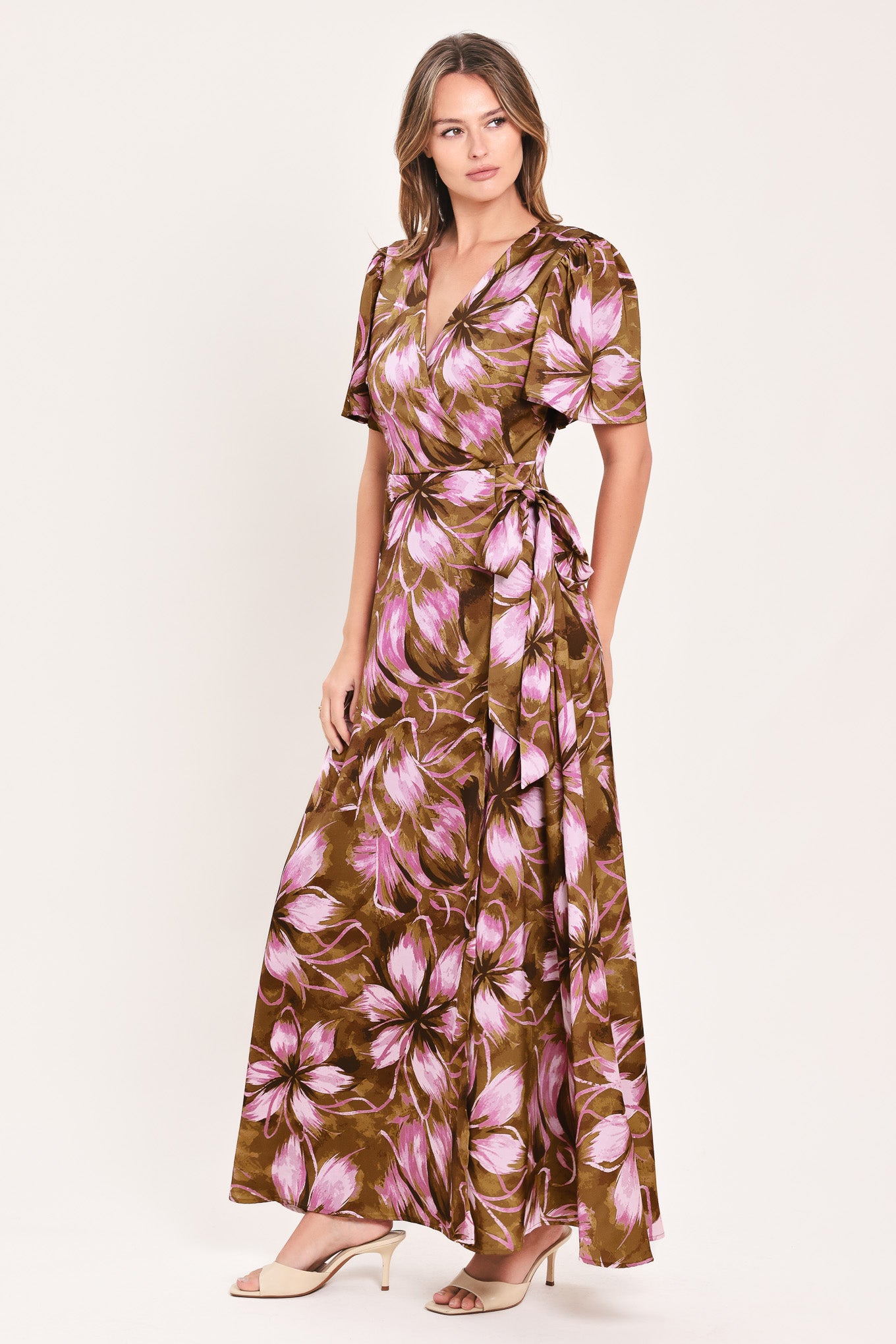 A woman modeling a brown and pink floral maxi dress with puff sleeves and a V-neckline | Flying Tomato
