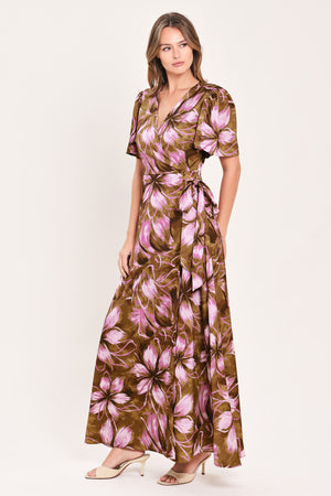 A woman modeling a brown and pink floral maxi dress with puff sleeves and a V-neckline | Flying Tomato