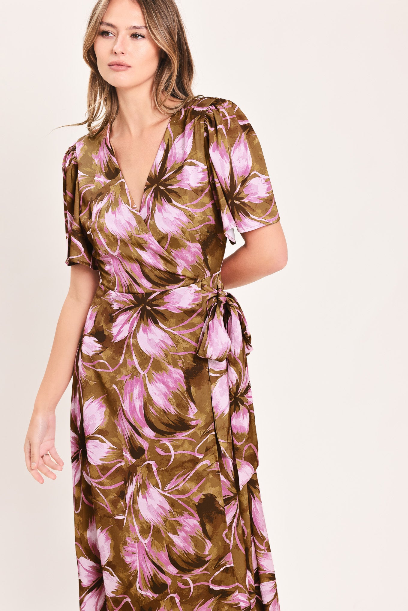 A woman modeling a brown and pink floral maxi dress with puff sleeves and a V-neckline | Flying Tomato