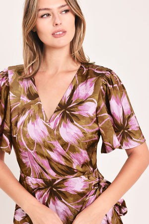 A woman modeling a brown and pink floral maxi dress with puff sleeves and a V-neckline | Flying Tomato