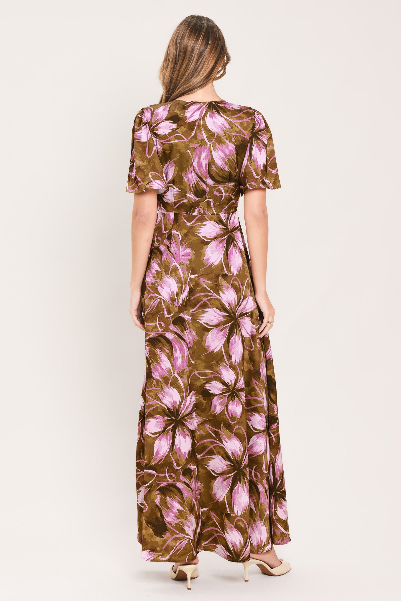 A woman modeling a brown and pink floral maxi dress with puff sleeves and a V-neckline | Flying Tomato