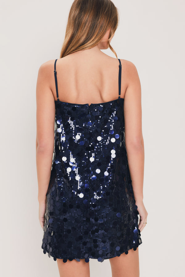 Woman wearing a navy spaghetti strap, square neck sequin mini dress | Flying Tomato