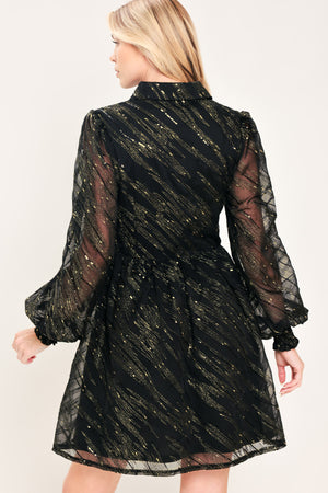 A model wearing a black sheer mini dress with gold glittery diagonal stripes, featuring long balloon sleeves and a flared skirt | Flying Tomato
