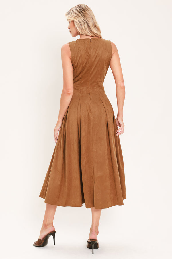 A woman modeling a sleeveless, midi-length camel brown faux suede dress with a button-down front | Flying Tomato