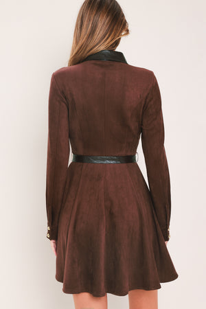 A woman modeling a burgundy suede long-sleeve shirt dress with a black faux-leather collar, button placket, and matching black tie belt | Flying Tomato