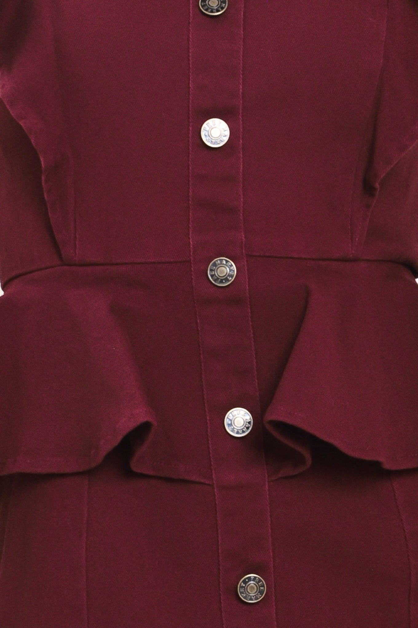 A woman modeling a sleeveless burgundy midi dress with ruffled cap sleeves, a peplum waist, and a front button placket | Flying Tomato