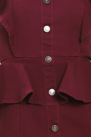 A woman modeling a sleeveless burgundy midi dress with ruffled cap sleeves, a peplum waist, and a front button placket | Flying Tomato