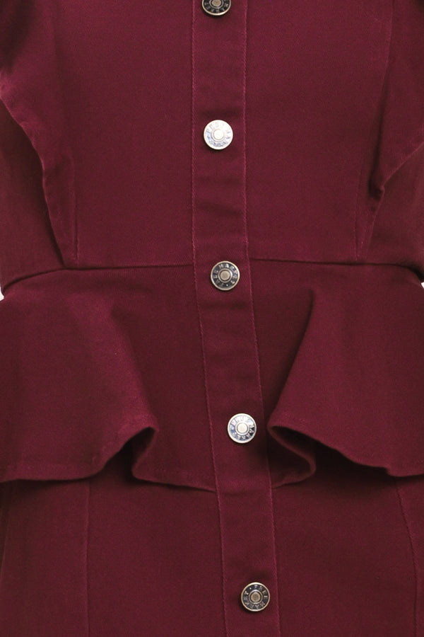 A woman modeling a sleeveless burgundy midi dress with ruffled cap sleeves, a peplum waist, and a front button placket | Flying Tomato