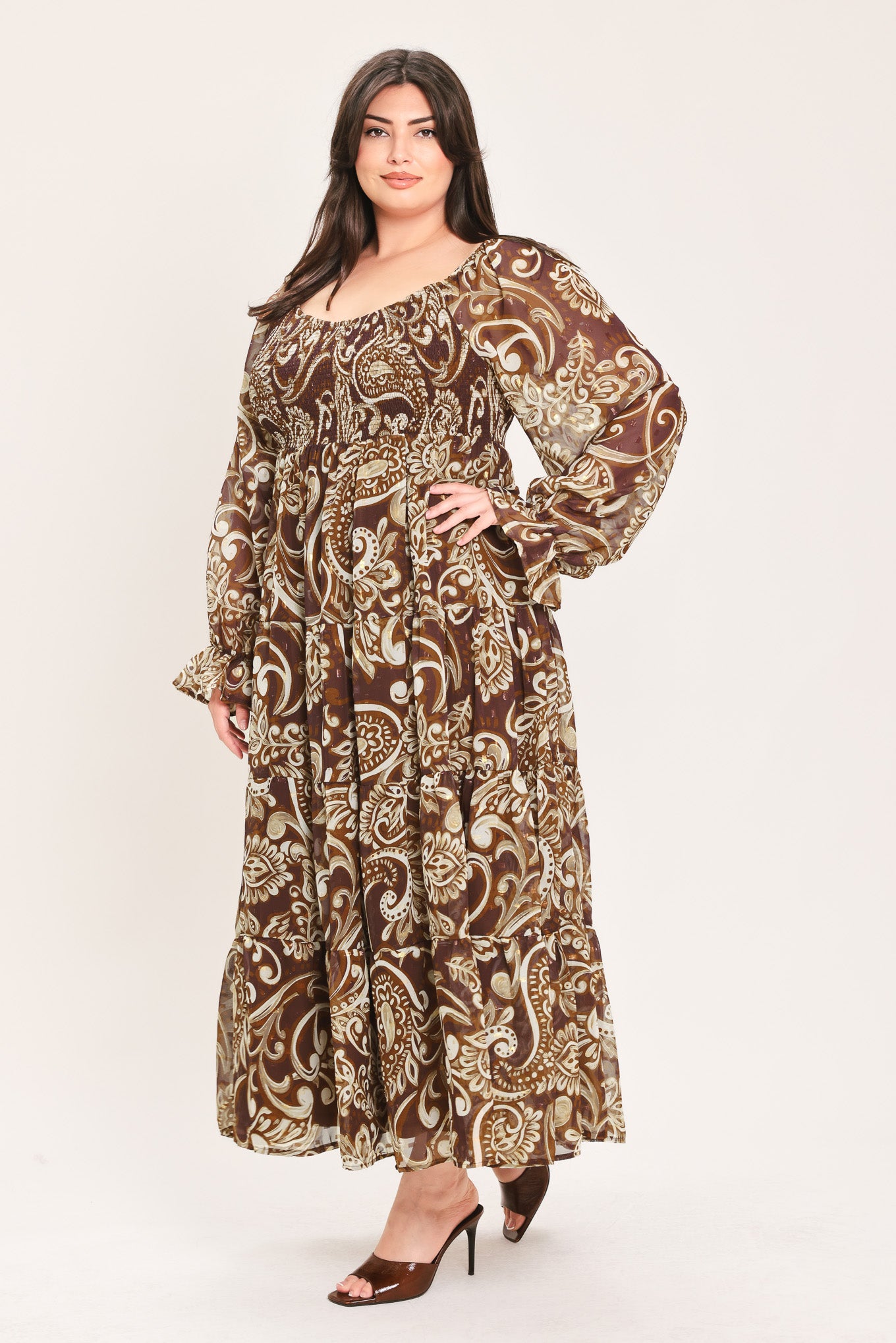 A woman wearing a long-sleeved midi dress with a brown and beige paisley pattern | Flying Tomato Curve