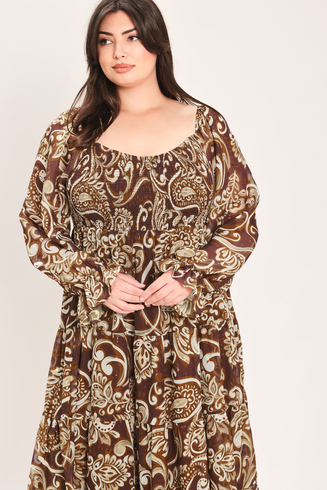 A woman wearing a long-sleeved midi dress with a brown and beige paisley pattern | Flying Tomato Curve