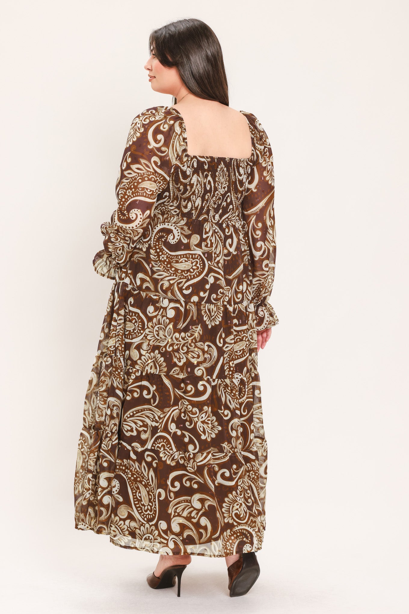 A woman wearing a long-sleeved midi dress with a brown and beige paisley pattern | Flying Tomato Curve