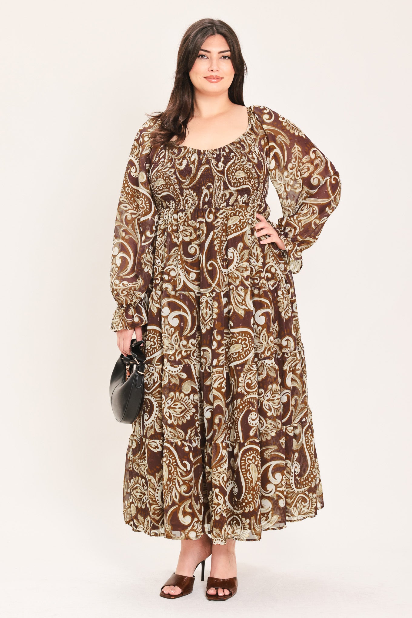 A woman wearing a long-sleeved midi dress with a brown and beige paisley pattern | Flying Tomato Curve