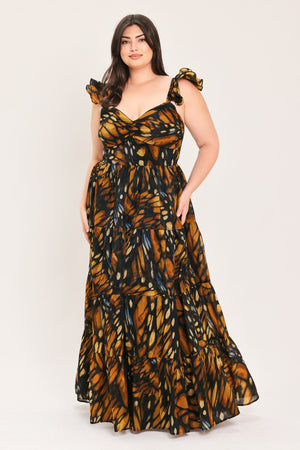 A woman modeling a floor-length tiered maxi dress with a black and orange butterfly wing print, featuring ruffled shoulder straps and a sweetheart neckline, set against a plain light gray studio background | Flying Tomato Curve